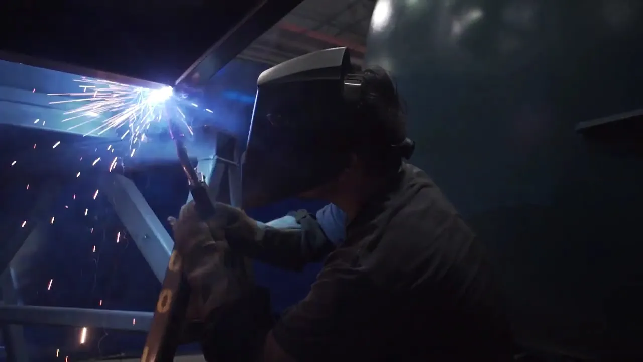 An ASC welder at work in a shower of sparks